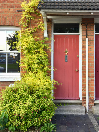 Old house with a old red doors and knocker.のeditorial素材