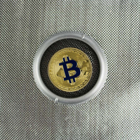 Cryptocurrency physical gold bitcoin coin on silver backgroundのeditorial素材