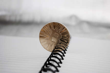 Digital currency physical gold bitcoin coin in notebook.の写真素材