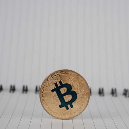 Cryptocurrency gold bitcoin coin in notebookの写真素材