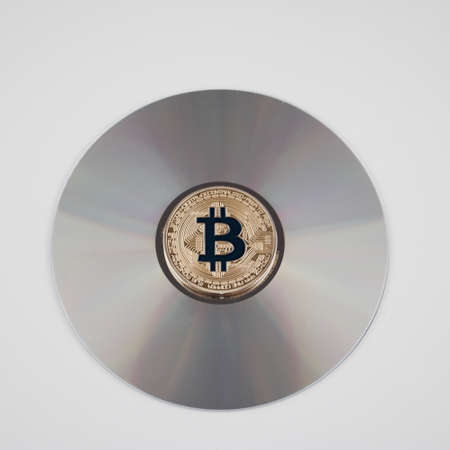 Digital currency physical gold bitcoin coin on the CD. Financial concept.の写真素材