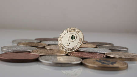 Digital currency physical gold peercoin coin with green leaf and bitcoin coins.の写真素材