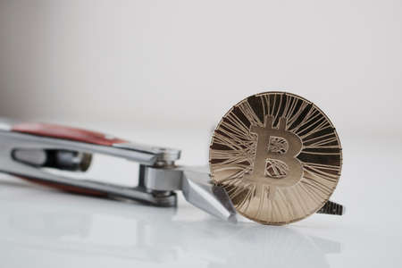 Cryptocurrency physical gold bitcoin coin and pocket knife. Men's toys.の写真素材