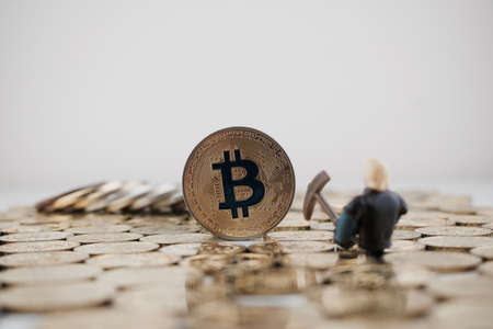 Cryptocurrency physical gold bitcoin coin near miner on the gold.の写真素材