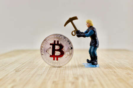 Digital currency physical silver bitcoin coin near miner.の写真素材