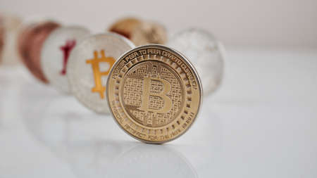 Digital currency physical gold bitcoin coin on white table.の写真素材