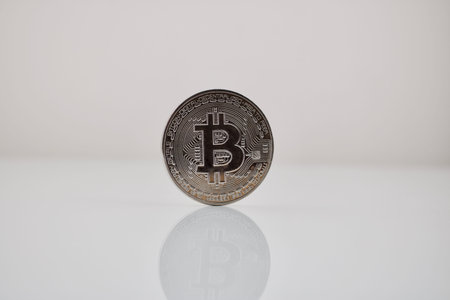 Digital currency physical silver bitcoin coin on white table.の写真素材