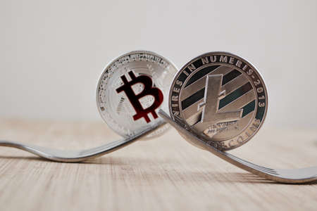 Digital currency physical silver litecoin coin and bitcoin with red sign.の写真素材