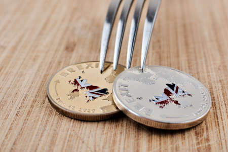 Physical brexit coin on the wooden board. Europe leaving concept.の写真素材