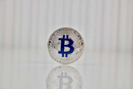 Digital currency physcial blue bitcoin coin on white background.の写真素材