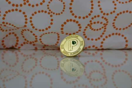 Digital currency physical gold peercoin coin with green leaf in P sign on the white background.の写真素材