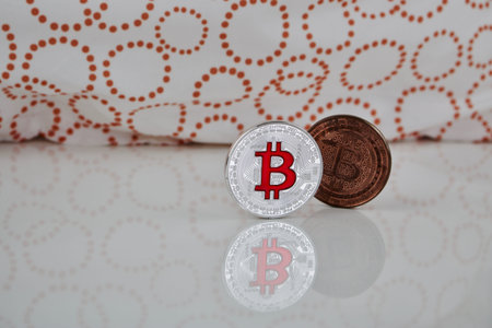 Cryptocurrency physical silver bitcoin coin and brass bitcoin on the white scene.の写真素材