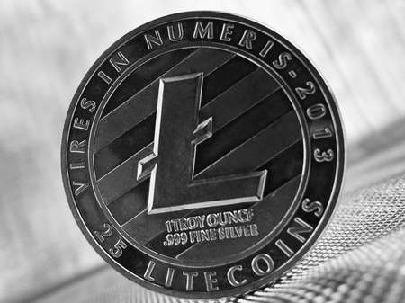 Digital currency physical silver litecoin coin on silver background.のeditorial素材