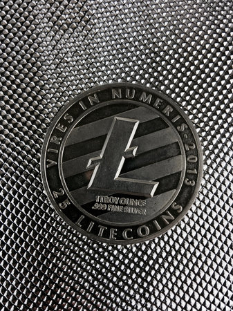 Digital currency physical silver litecoin coin on the silver background