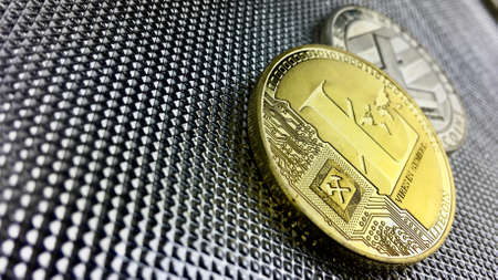 Digital currency physical gold litecoin coin near silver background.のeditorial素材