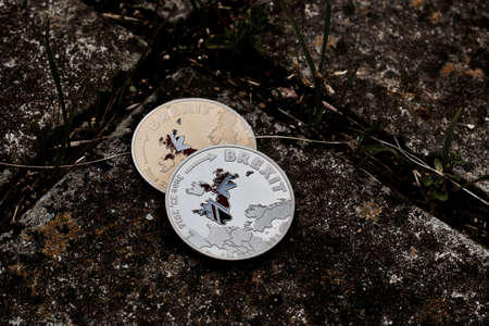 Europe leaving. United Kingdom brexit gold and silver coin with map.の写真素材