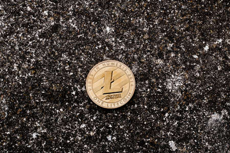 Cryptocurrency physical gold litecoin coin on black dark background.の写真素材