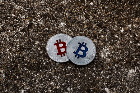 Digital currency physical silver bitcoin coins on dark scene. Red and blue concept.の写真素材