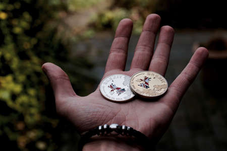 Europe leaving. Silver and gold brexit coins with british map. England.の写真素材