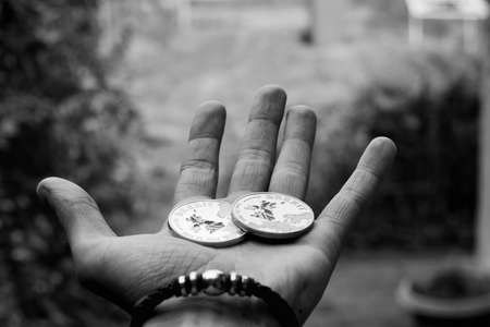 Europe leaving. Two big brexit coins with british map on man hand. Black and white concept.の写真素材