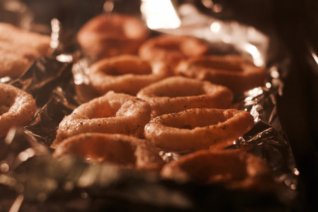 Delicious and fresh onion rings baking in hot oven. Natural food.の写真素材