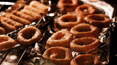 Delicious and fresh onion rings in hot oven. Baking food in the kitchen.の写真素材