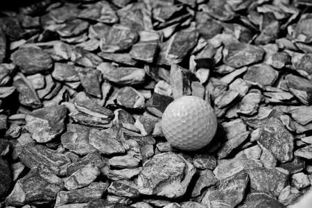 Small white dirty gold ball staying on grey stones. Closeup photography.の写真素材