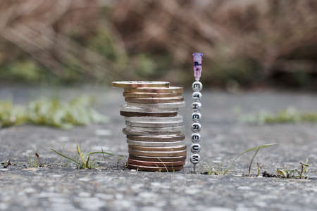 Digital currency physical silver and gold coins near ethereum inscription on the needle.の写真素材