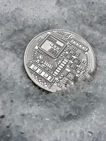 Digital currency physical metal coin on the white cristal background. Virtual cash concept.の写真素材