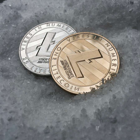 Digital currency physical metal coin on the white cristal background. Virtual cash concept.の写真素材