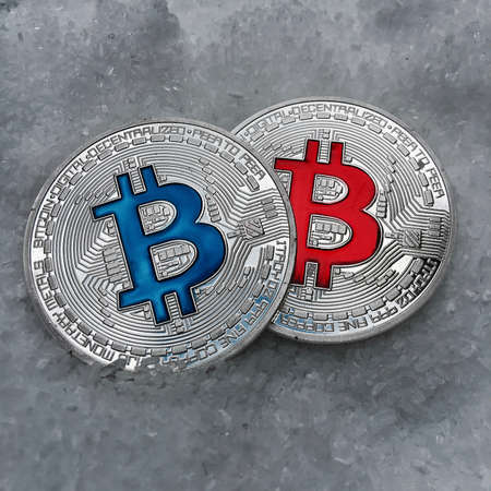 Digital currency physical metal coin on the white cristal background. Virtual cash concept.の写真素材