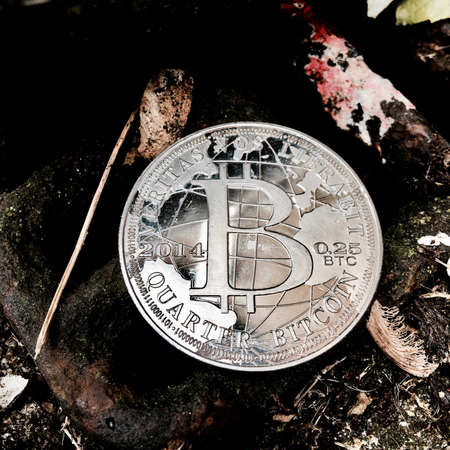 Digital currency physical metal coin on the white cristal background. Virtual cash concept.の写真素材