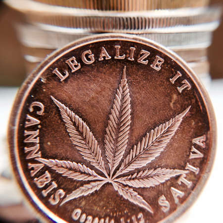 Brass marijuana coin with cannabis leaf. Legalize it. Sativa.の写真素材