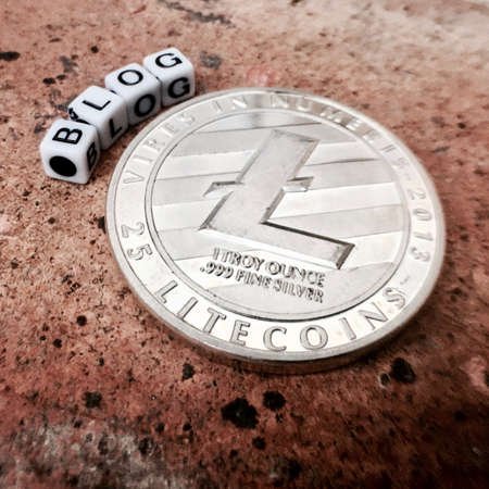 Digital currency physical metal litecoin coin near white square blog inscription.の写真素材