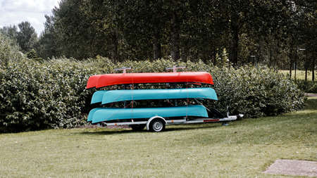 Red and blue kayak on the trailer in Milton Keynes. Summer in park.の写真素材