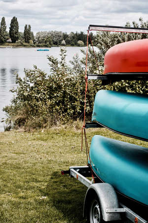 Blue and red kayak on the trailer near lake in Milton Keynes. Bedfordshire.の写真素材