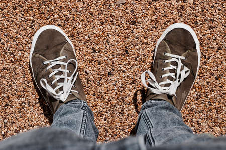 Man in brown shoes stayin on the stone floor. Grey trousers.の写真素材