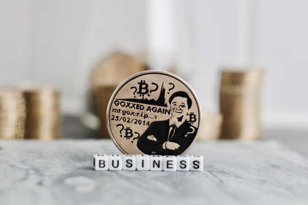 Digital currency physical metal bitcoin coin near business white letters inscription.の写真素材