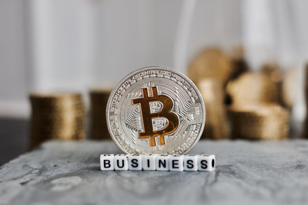 Digital currency physical metal bitcoin coin near business white letters inscription.の写真素材