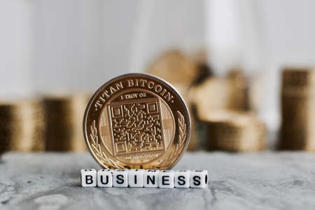 Digital currency physical metal bitcoin coin near business white letters inscription.の写真素材
