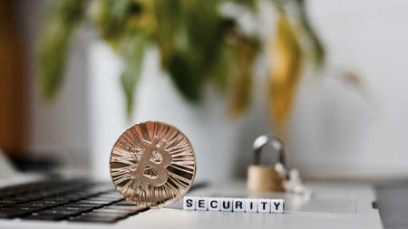 Digital currency physical metal bitcoin coin on the keyboard. Bitcoin security.の写真素材
