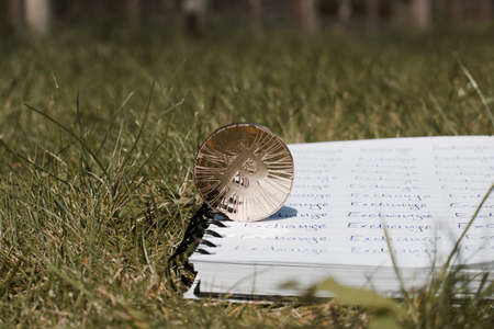 Digital currency physical metal bitcoin coin on the notebook with exchange inscription. Money outdoor concept.の写真素材