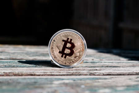Digital currency physical gold red bitcoin coin. Outdoor money concept.の写真素材
