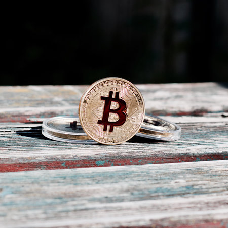 Digital currency physical gold red bitcoin coin. Outdoor money concept.
