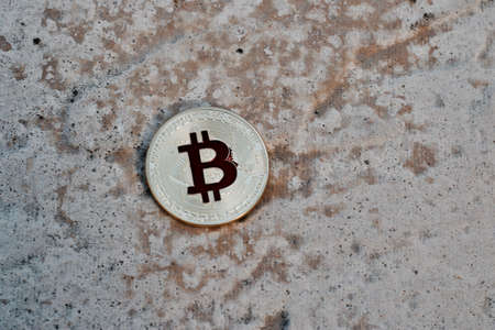 Digital currency physical gold red bitcoin coin. Outdoor money concept.の写真素材