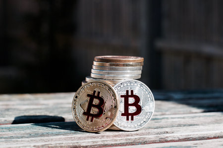 Digital currency physical gold red bitcoin coin. Outdoor money concept.