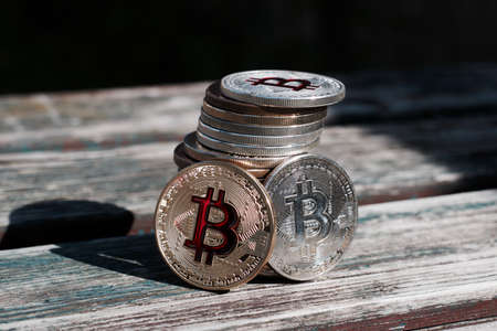 Digital currency physical gold red bitcoin coin. Outdoor money concept.の写真素材