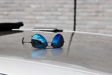 Blue sun glasses on the roof. Summer lifestyle conceptの写真素材