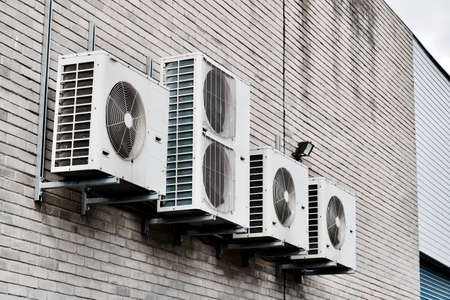 Few air condition machines on the brick wall in London. Brick warehouse air system.の写真素材