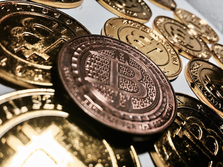 Digital currency physical metal bitcoin coin on the gold bitcoins. Cryptocurrency concept.